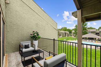 Private balcony with chair and table at Bremerton Park Apartment Homes , Kansas